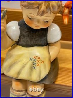 M I Hummel Goebel Nimble Fingers girl on wooden bench cross stitching HUM 758
